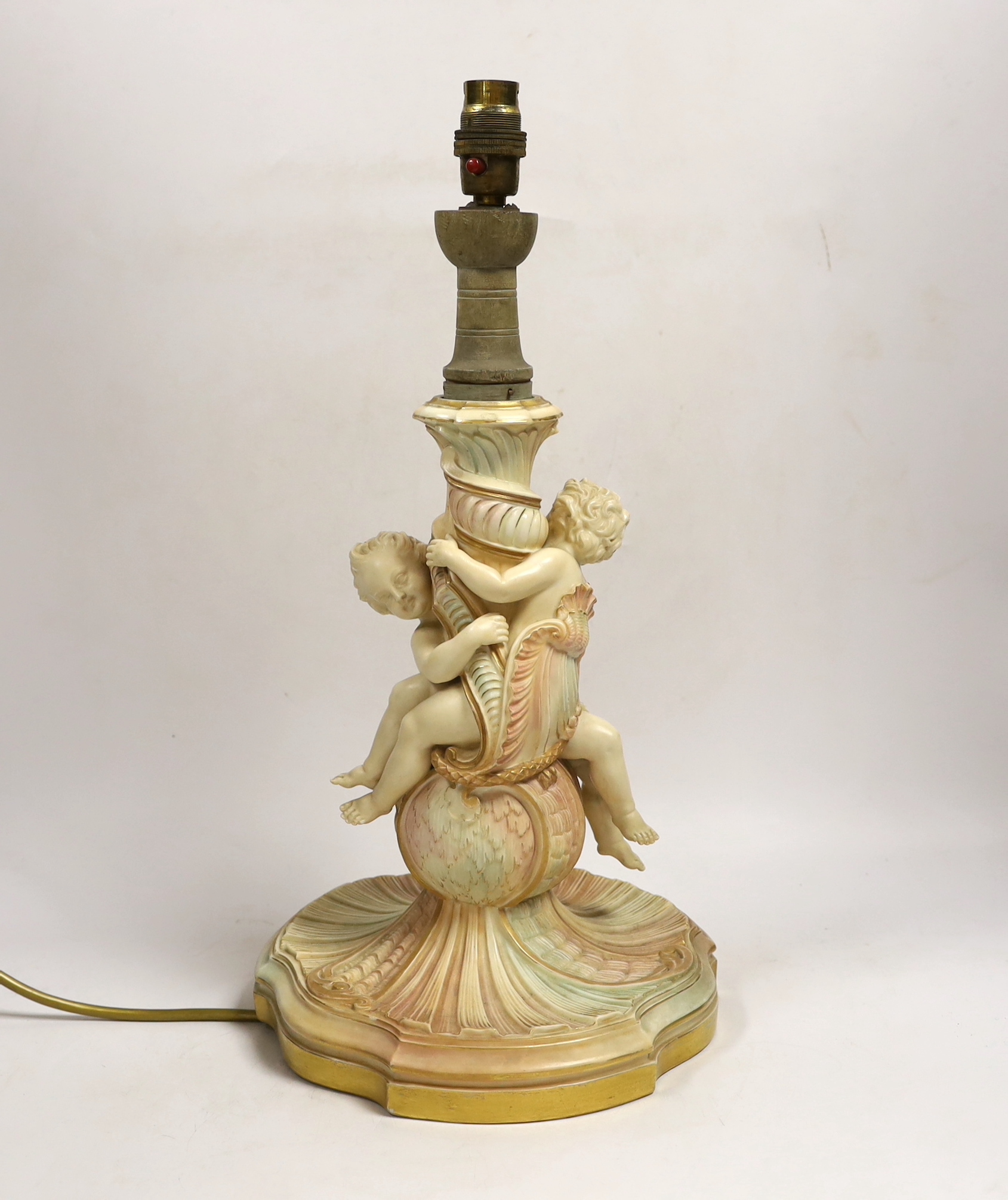 A large Royal Worcester blush ivory cherub lamp base, 40cms not including light fitting